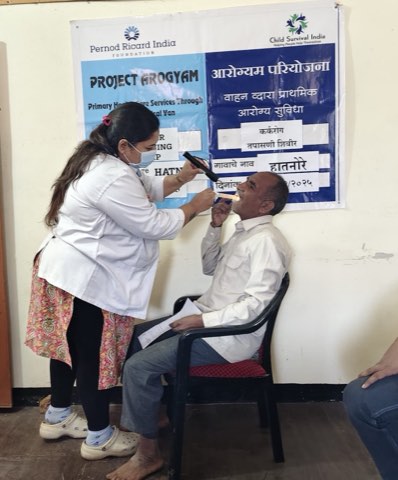 A cancer screening camp at Hatnore: an oral examination carried out with a torch and spatula.